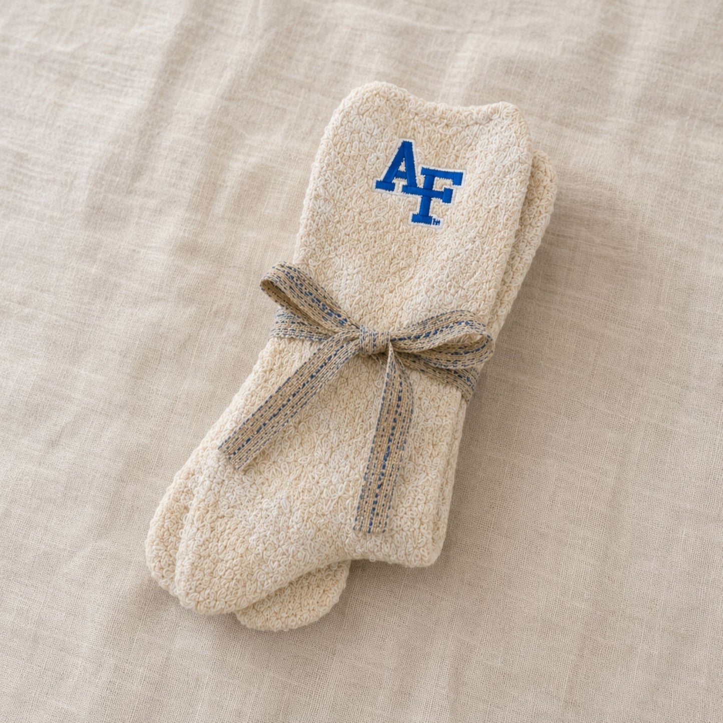 Air Force Academy Cozy Cabin Socks in cream with embroidered AF logo, plush soft texture for warmth and comfort