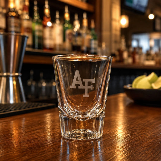 Clear 2 oz shot glass featuring a precision-etched AF logo on the front with a heavy glass base.