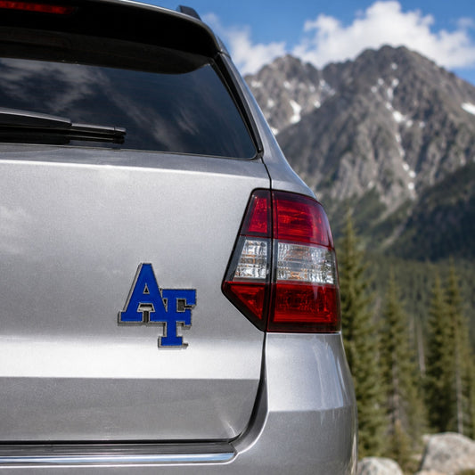 Pewter Air Force Academy interlocking AF auto emblem with blue enamel finish and adhesive backing, measuring 2.5 inches by 2.5 inches.