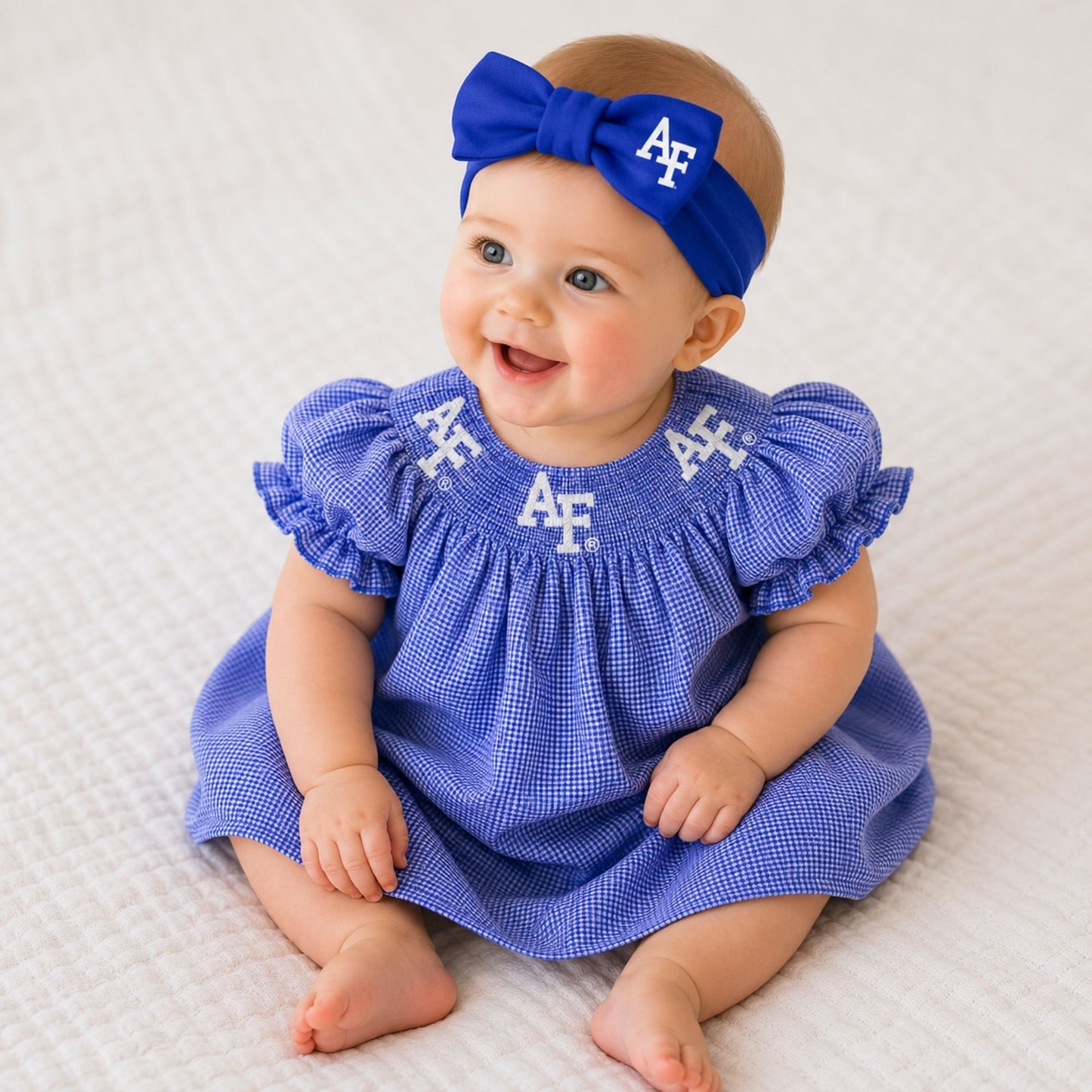 Royal blue Air Force baby hair bow headband featuring a large bow and white AF logo