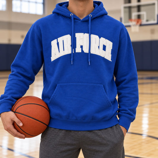 Model wearing the royal blue Air Force Courtside Hoodie while holding a basketball on an indoor court