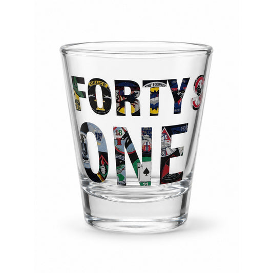 Clear glass shot glass featuring the phrase "Forty Squadrons. One Family." with artwork representing all 40 United States Air Force Academy cadet squadrons.