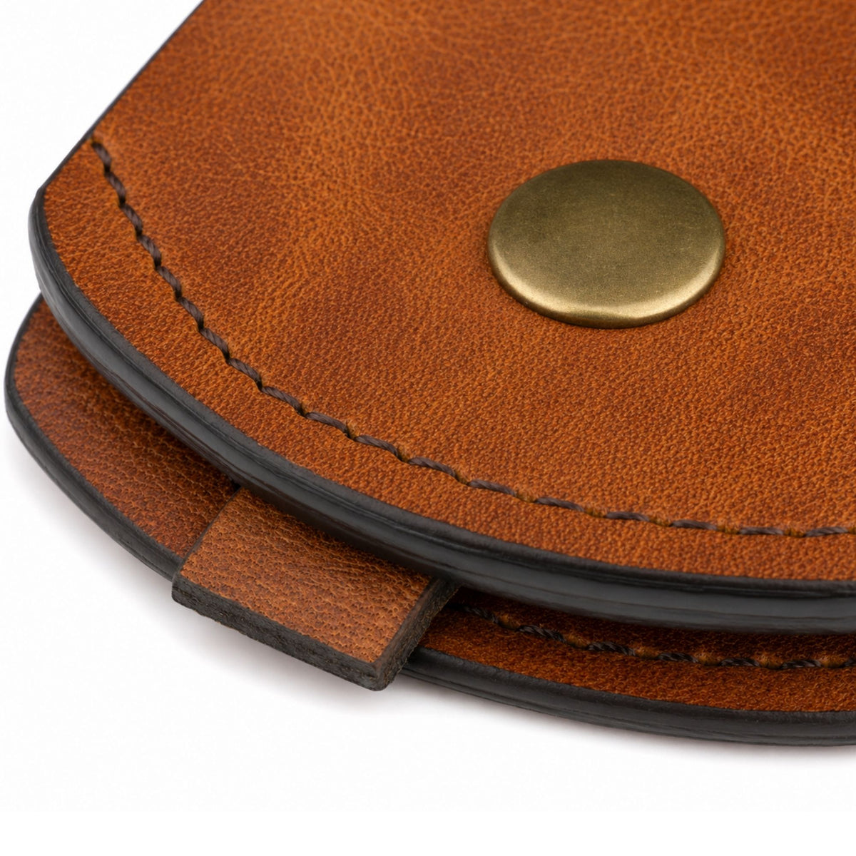 Close-up of the Heritage Gear Leather Luggage Tag showing its natural full-grain leather texture, dark stitching, finished edge, and metal snap.