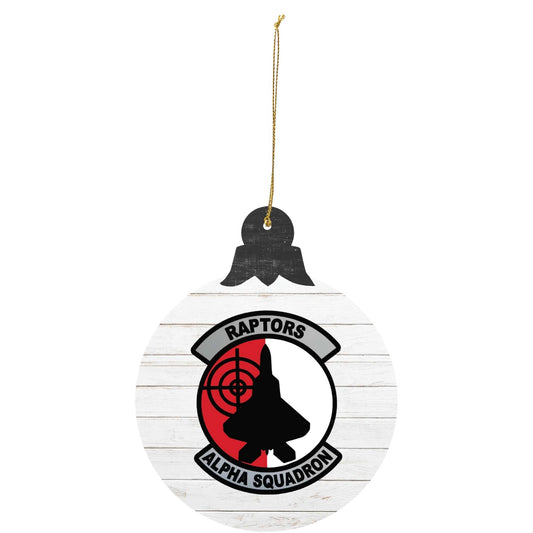 Raptors Alpha Squadron holiday ornament featuring squadron emblem on white wood-style background.