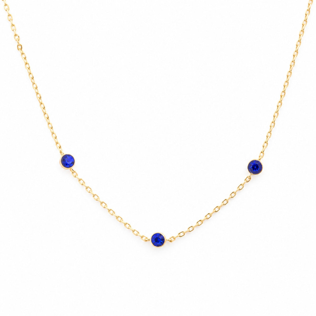Academy Gemstone Necklace with three royal-blue glass stones set along a delicate 18K gold-plated chain.