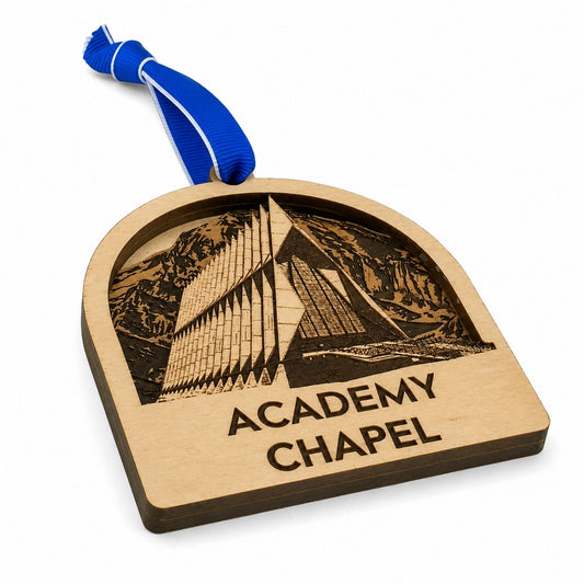 Cherry wood Academy Chapel ornament featuring a detailed laser-engraved design of the United States Air Force Academy Chapel with a royal blue hanging ribbon.