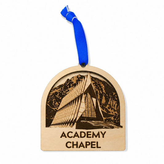 Cherry wood Academy Chapel ornament featuring a detailed laser-engraved design of the United States Air Force Academy Chapel with a royal blue hanging ribbon.