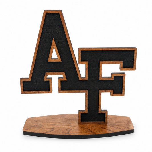 Cherry wood AF desk sitter featuring the iconic interlocking Air Force letters on a freestanding wooden base.