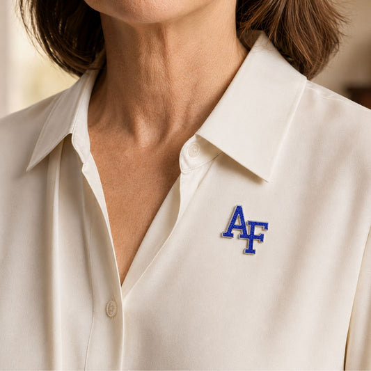 Air Force Academy AF emblem brooch with sapphire-colored Preciosa crystals and a silver-tone rhodium-plated border.