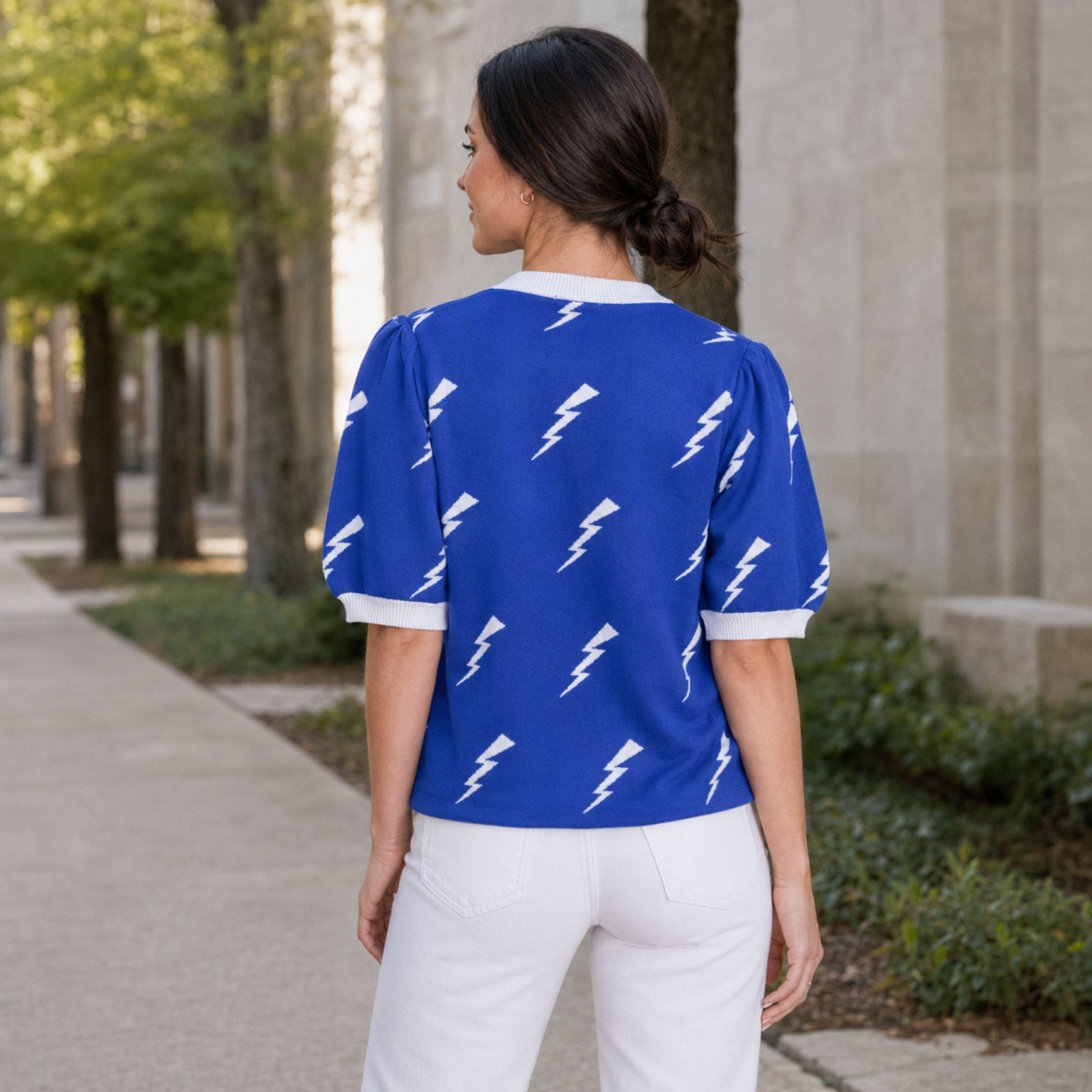 Blue Air Force Academy knit sweater top with white lightning bolts, puff sleeves and white ribbed trim