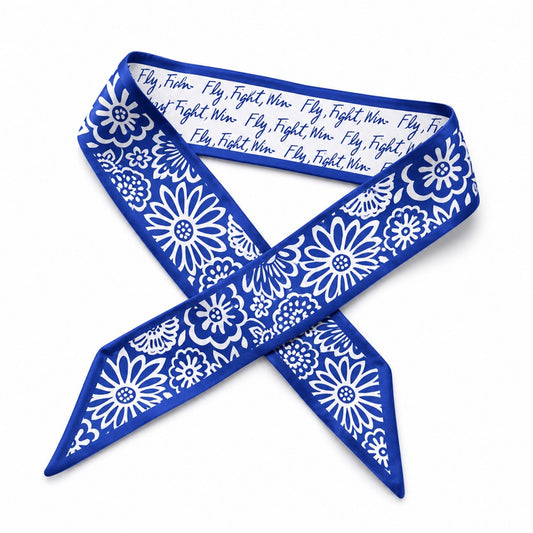 Air Force Academy satin skinny scarf with blue floral pattern and “Fly, Fight, Win” script styled in an X shape on a white background