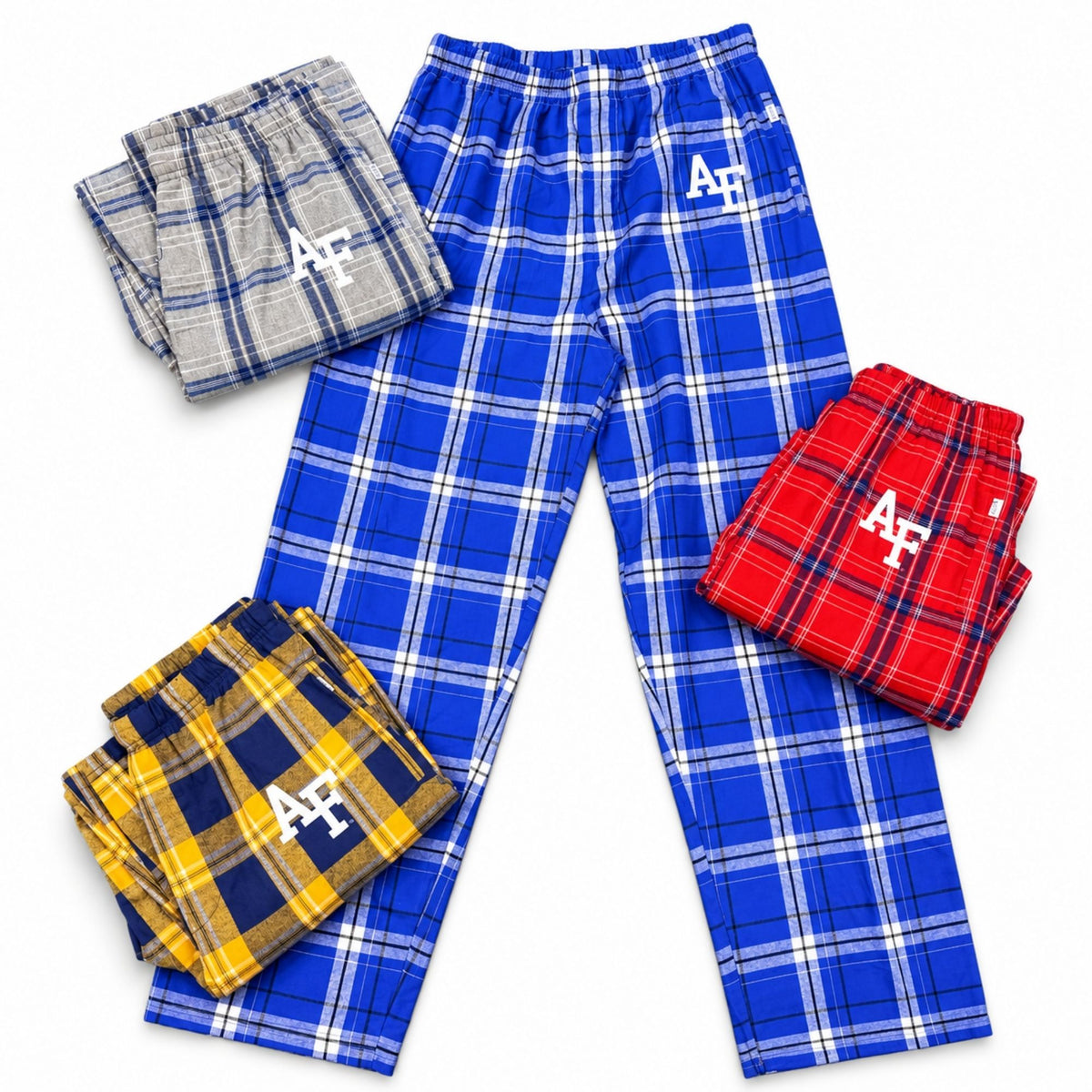 Air Force plaid pajama pants in blue, silver-gray, red, and gold, arranged with one pair laid flat and three folded.