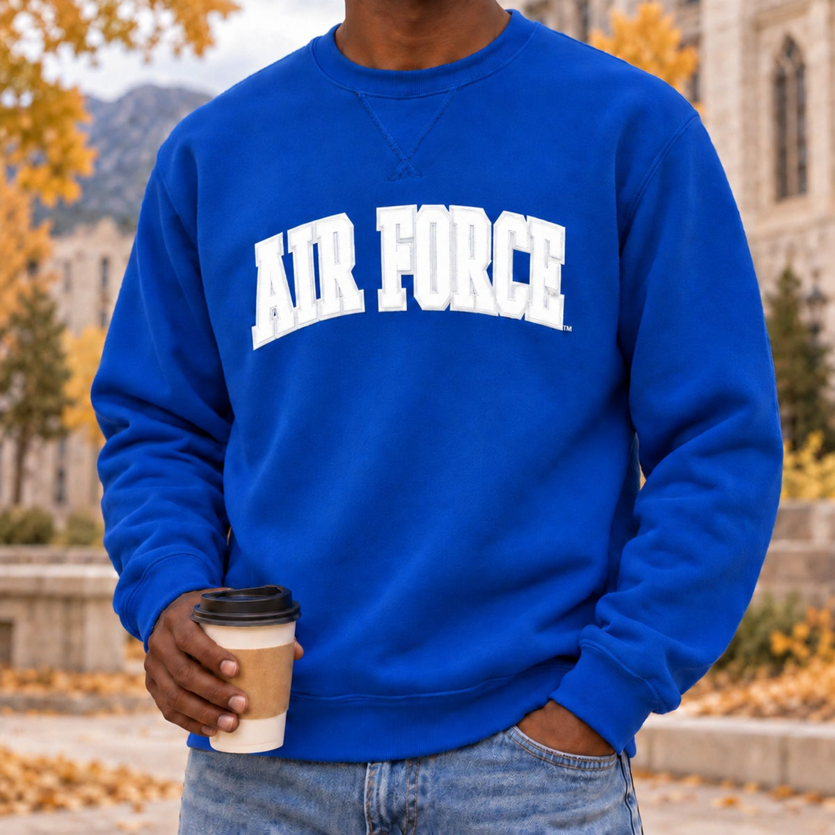 Person wearing the blue Air Force Courtside Crewneck outdoors in fall
