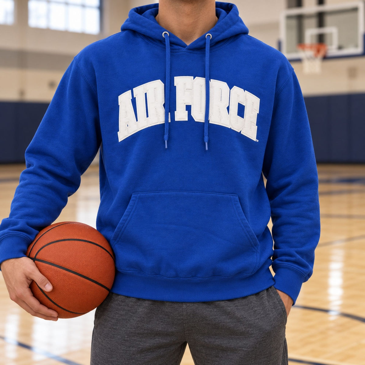 Model wearing the royal blue Air Force Courtside Hoodie while holding a basketball on an indoor court