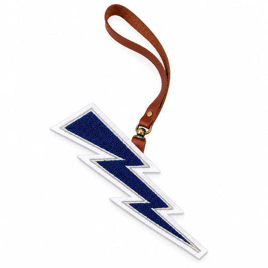 Air Force Lightning Bolt Chenille Bag Charm featuring a navy blue and white chenille lightning bolt, brown leather loop strap, and antique brass hardware.