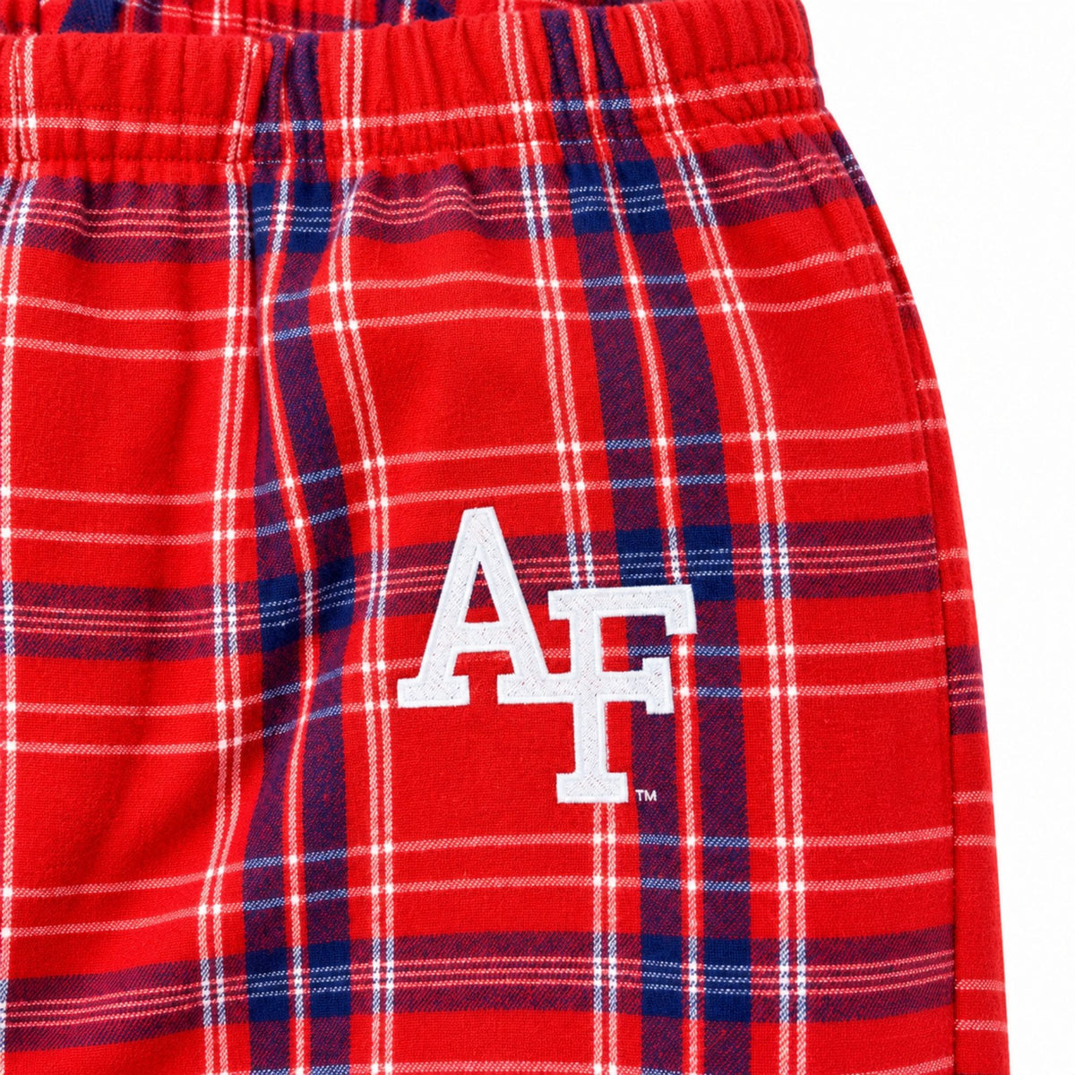 Close-up of white embroidered AF logo and elastic waistband on red pajama pants with navy and white plaid.