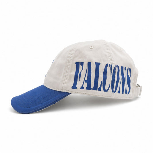 Side view of the cream and royal blue FALCONS Sideshow Hat with oversized wraparound FALCONS lettering.