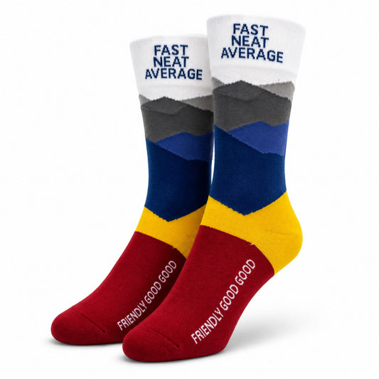 Crew socks featuring Fast Neat Average on the cuff, Friendly Good Good on the foot, and a colorful mountain-inspired design in USAFA colors.