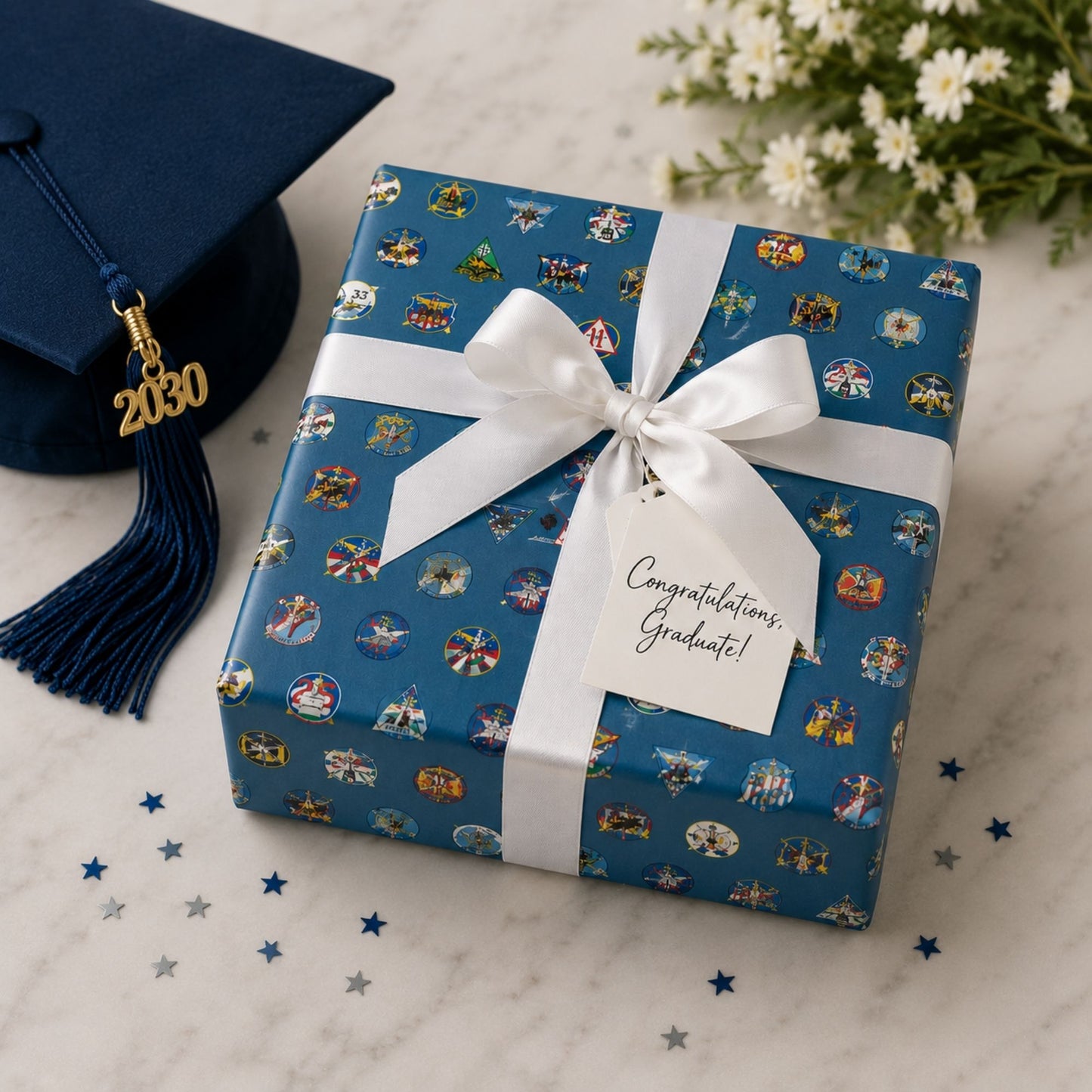 Roll of Forty Squadron Wrapping Paper featuring colorful USAFA squadron emblems on a steel blue background.