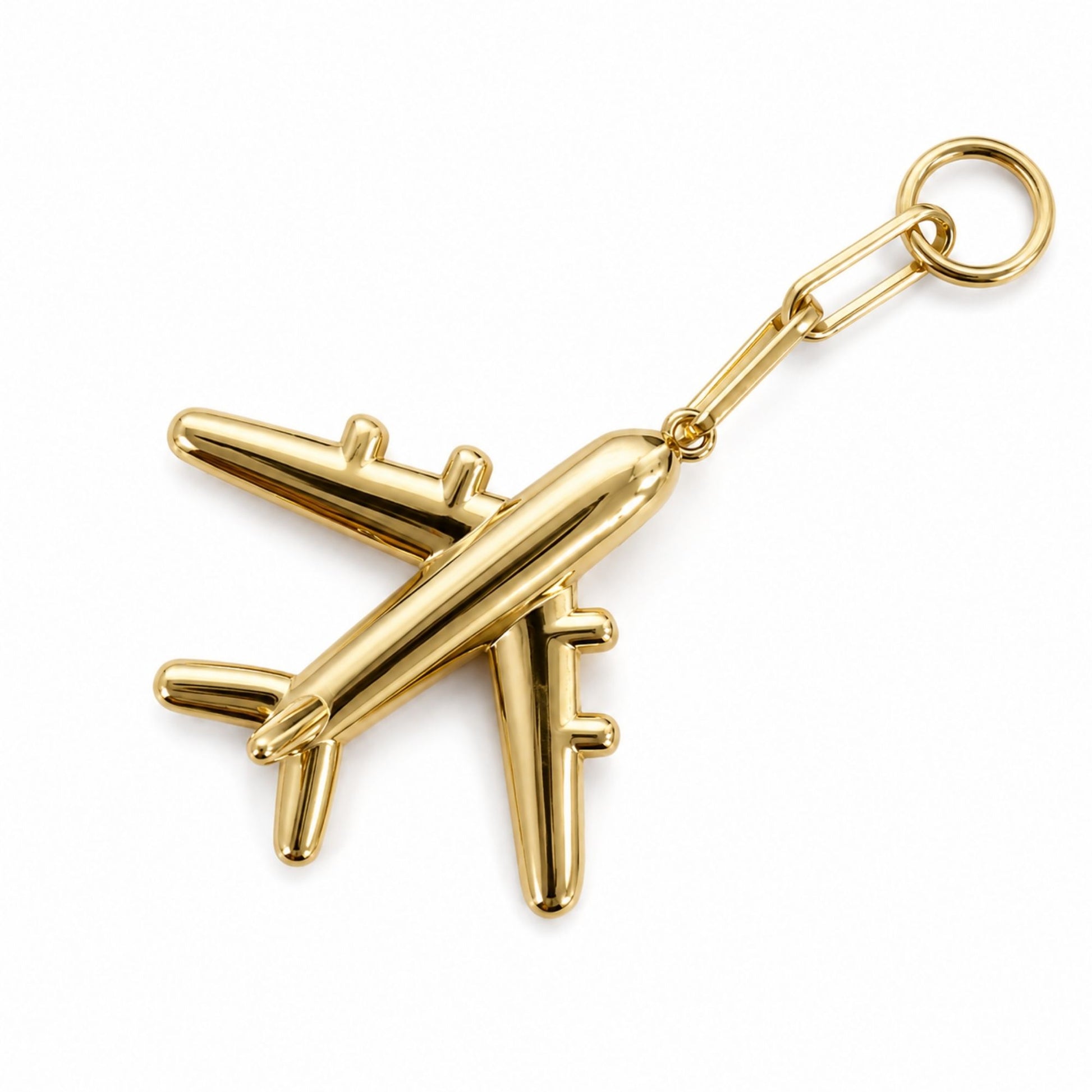Polished gold airplane bag charm with attachment ring and connector on a white background.