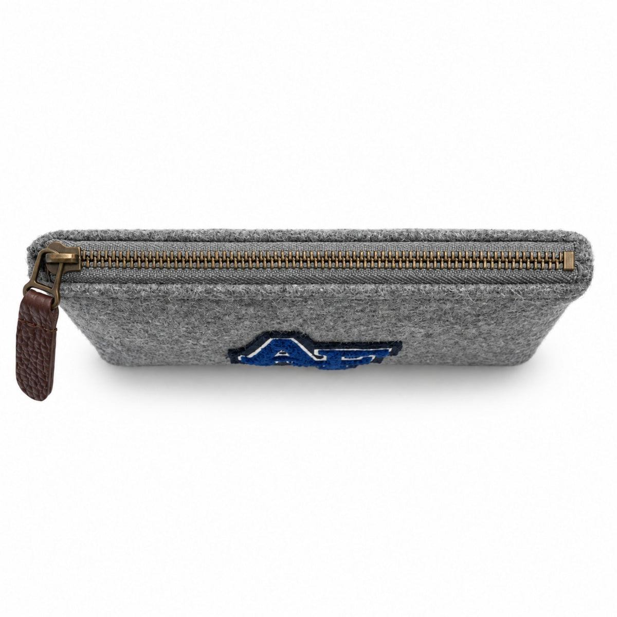 Top view of the grey Melton Wool Valuables Pouch with an antique brass zipper and brown leather pull.