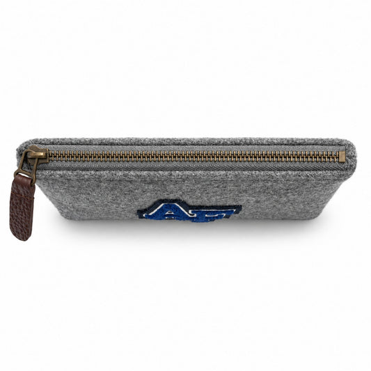Top view of the grey Melton Wool Valuables Pouch with an antique brass zipper and brown leather pull.