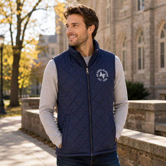 Men's Air Force Academy navy diamond quilt vest with embroidered Air Force Academy graphic, full-zip front, stand-up collar, hand pockets, and drop-tail hem.