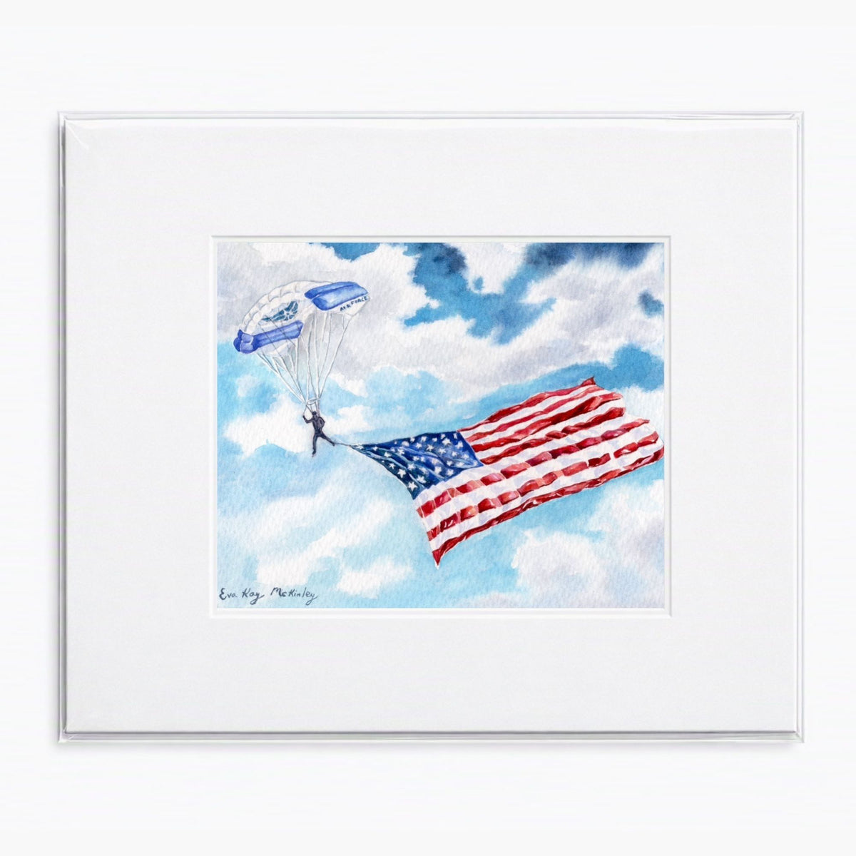 Matted watercolor painting of a USAFA Wings of Blue parachutist carrying the American flag.
