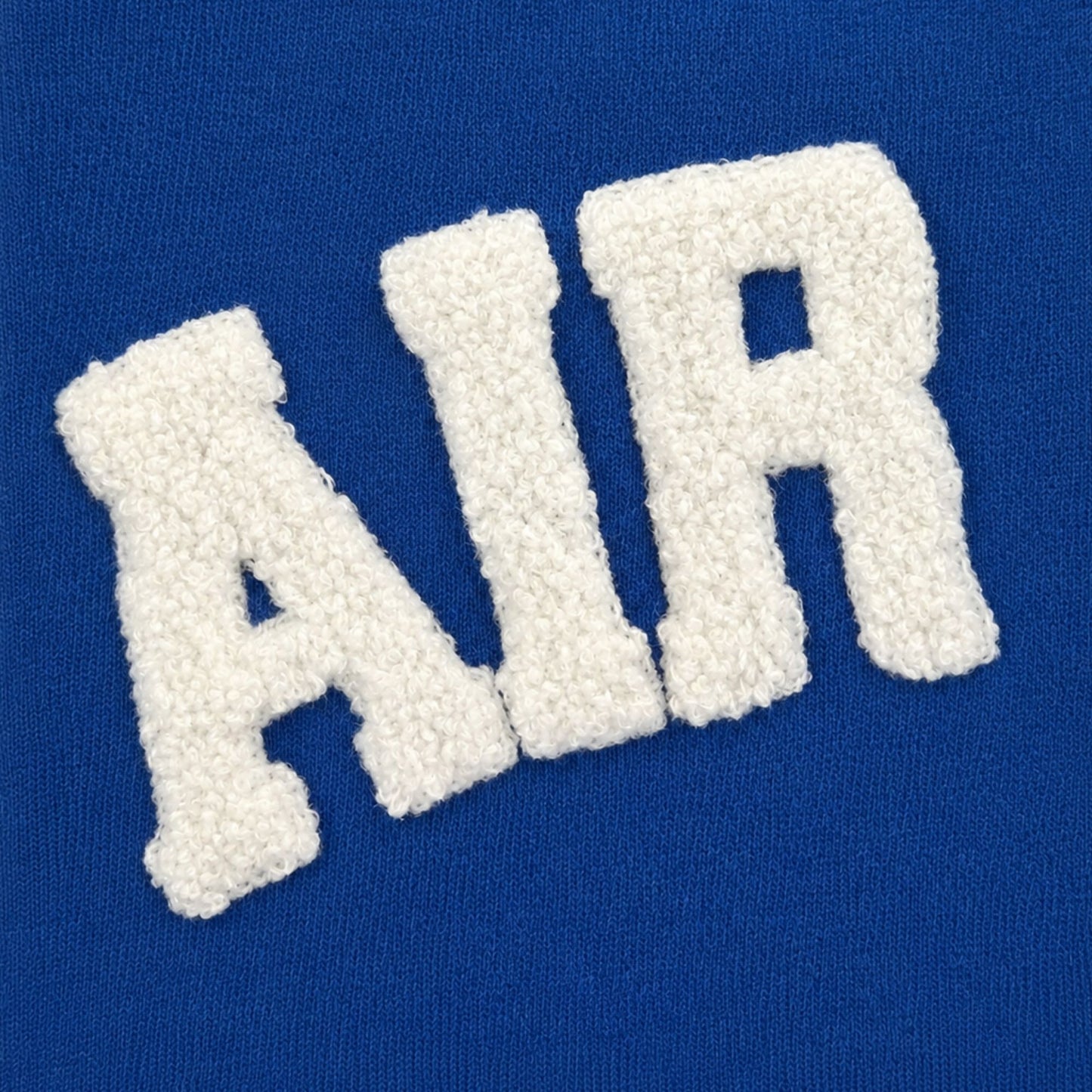 Royal blue Varsity Chenille Poncho with oversized white AIR FORCE chenille lettering and a distressed neckline.